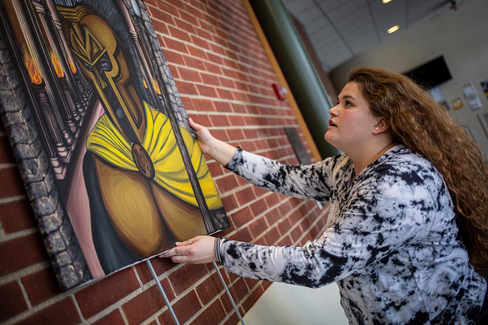 A series of art is hung depicting the Manchester Spartan mascot, Manny, as a real historical Spartan.