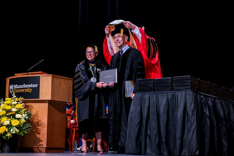 Dave Haist is hooded with an honorary doctorate degree from Manchester University