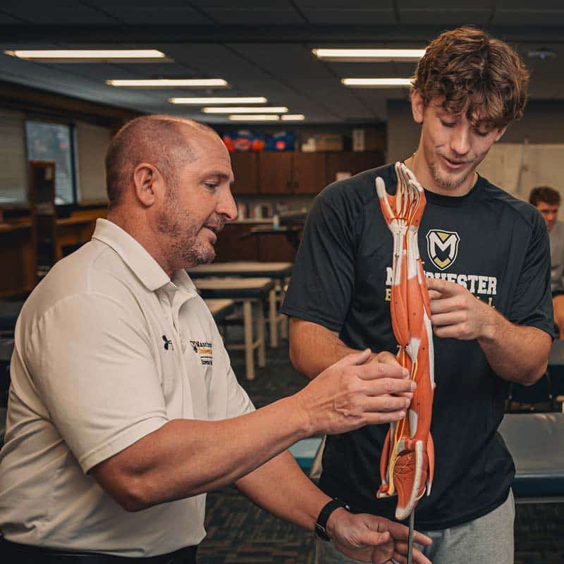 Dr. Jeff Beer demonstrates in the Pre-Athletic Training lab on Manchester Campus.