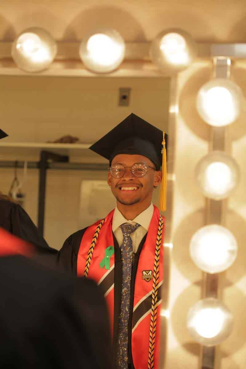 Manchester University UG student double checks himself in the mirror prior to ceremony.