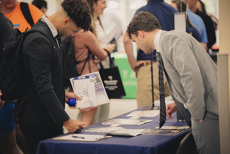 Students meet with potential employers during a networking event.