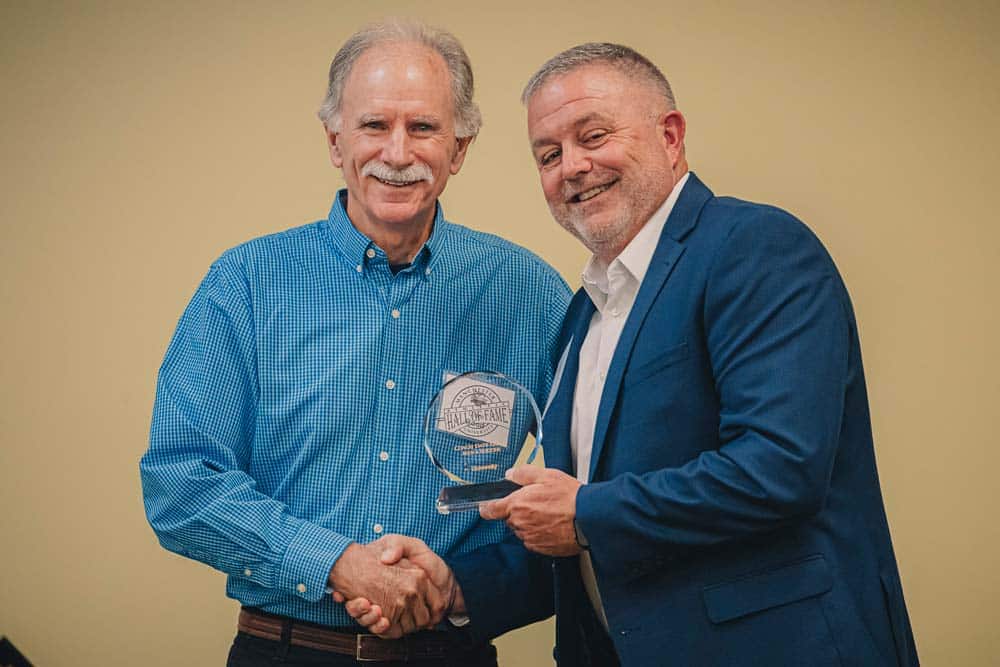 Alumni is presented with an Athletic Hall of Fame award