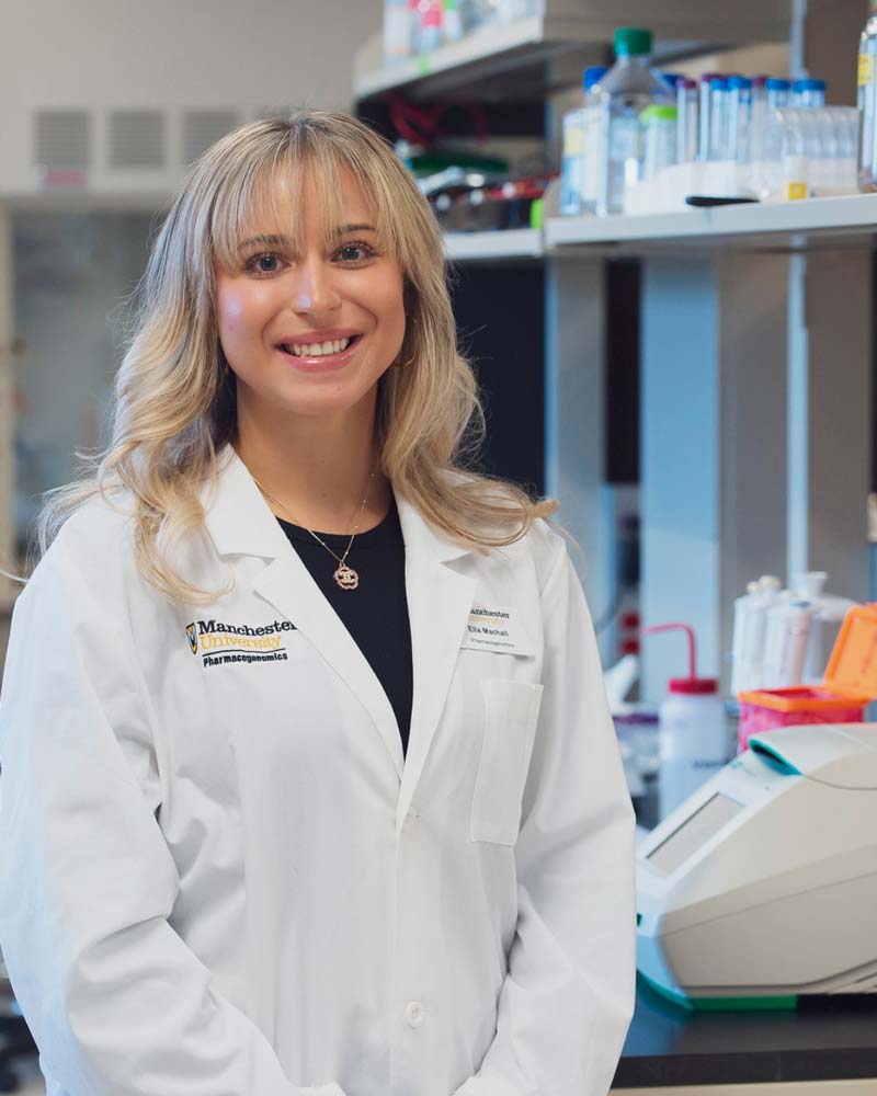 PGxPrePro Female PGx student in a white lab coat.