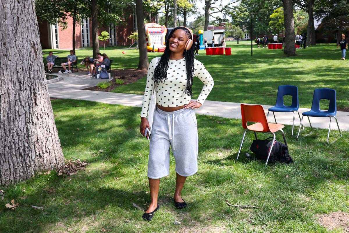WeekOfWelcomeSolo A student poses during the WOW event - Week of WElcome - wearing their headphones and a smile.