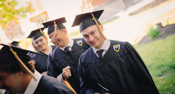 A graduate student smiles for the camera