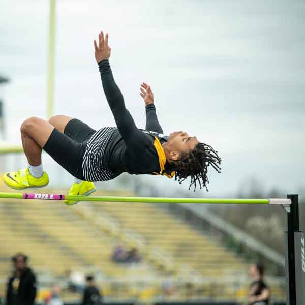 HighJumpWR Manchester University Athletics student of color leaps over the high jump bar.