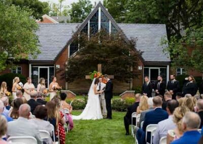 Bride and Groom stand together at the alter trading vows.